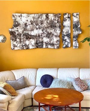 Abstract wall art above cozy living room.