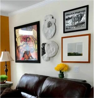Living room with eclectic wall art display.