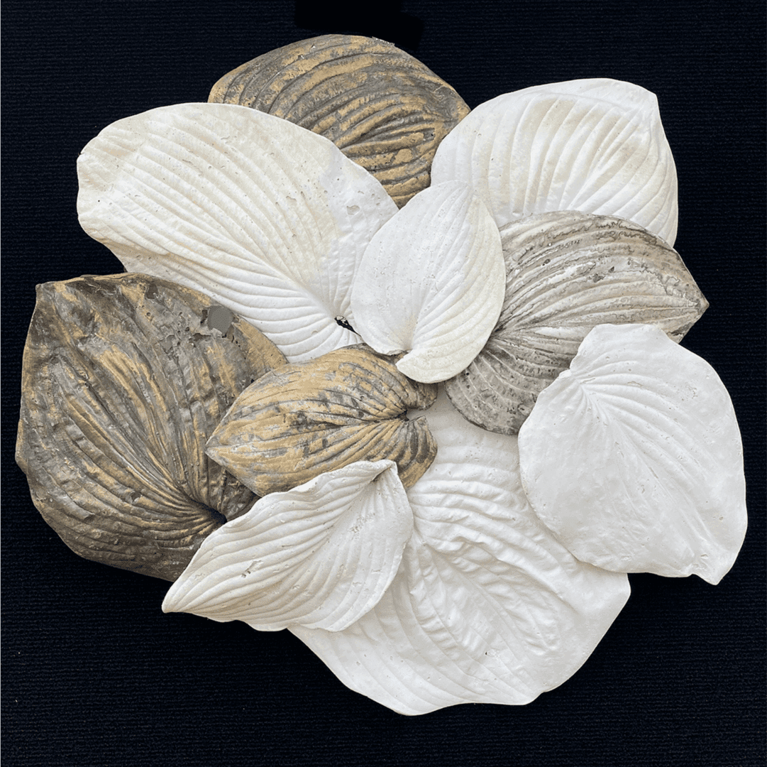 Sculpted leaves in various colors on black.