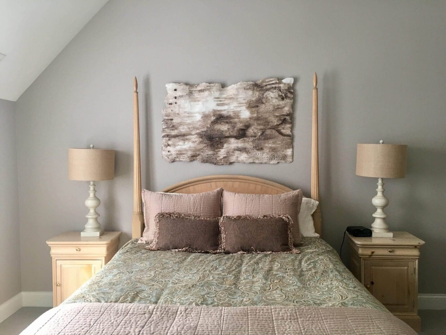 Elegant bedroom with a neutral color palette and abstract wall art.