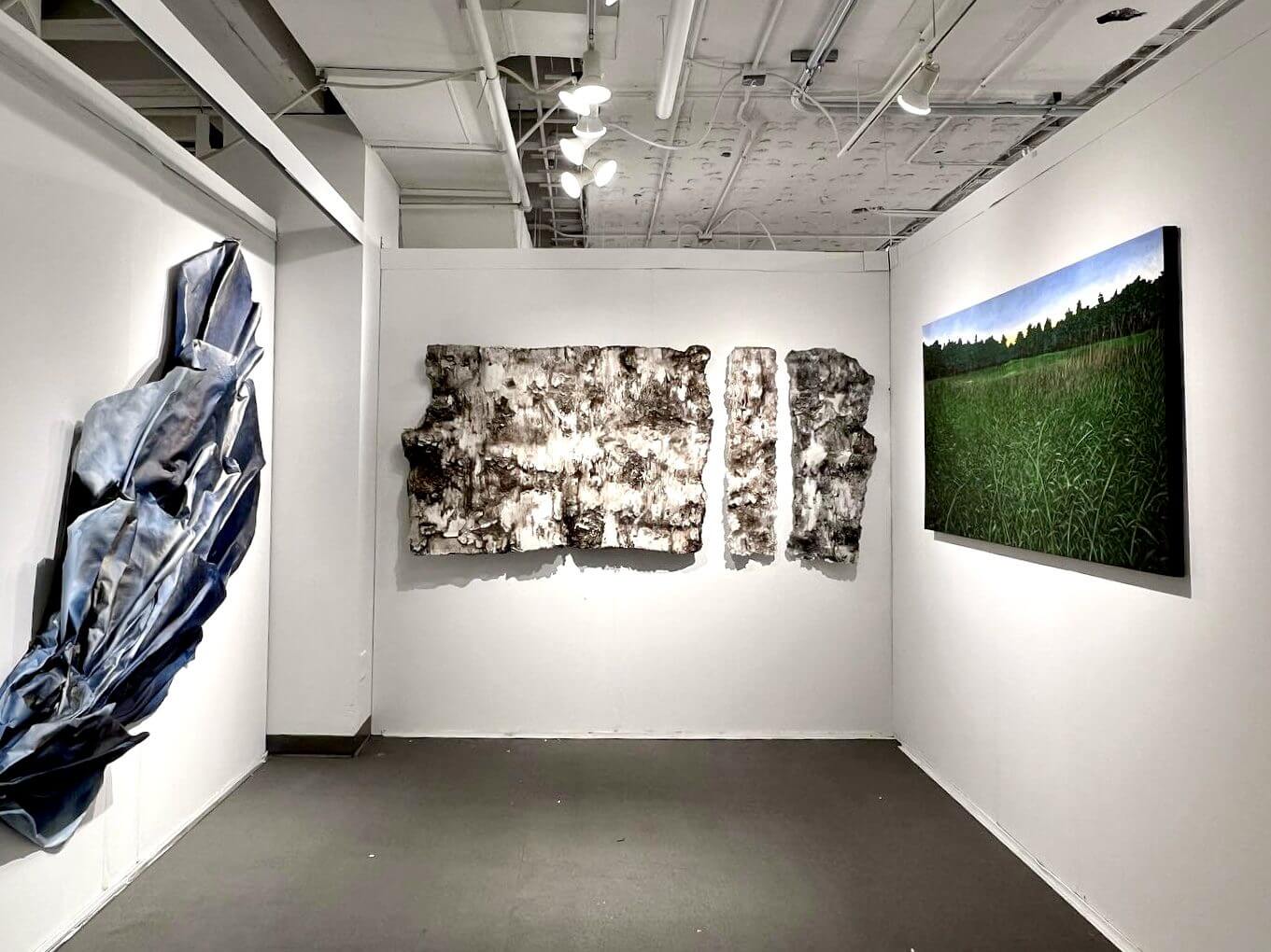 Modern art pieces displayed in a minimalist gallery space.