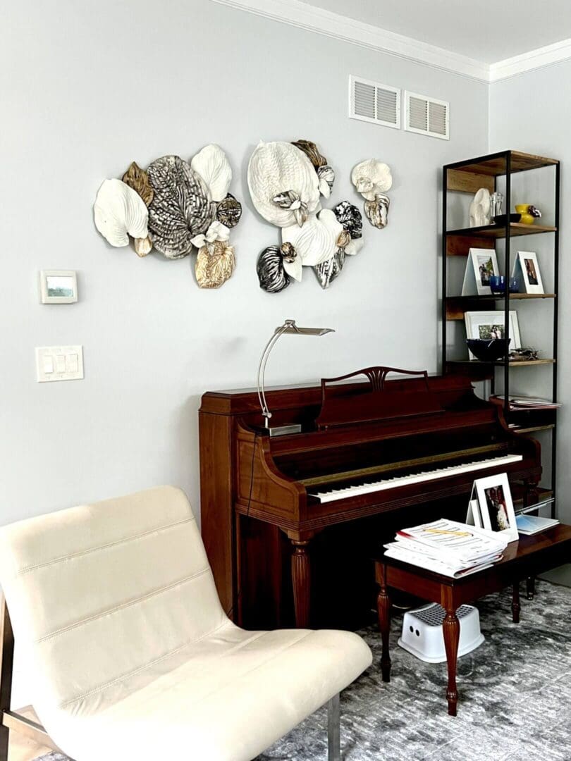 Cozy living room corner with a classic upright piano and modern wall art.