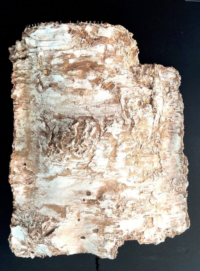 Ancient stone tablet with carved inscriptions and weathered surface.