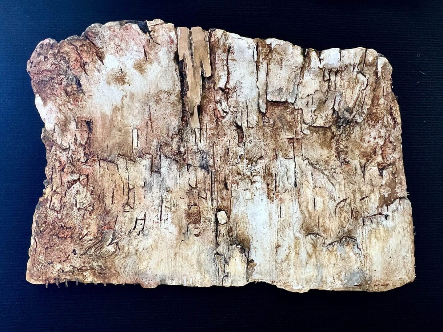 Ancient weathered parchment with faded inscriptions and cracks.