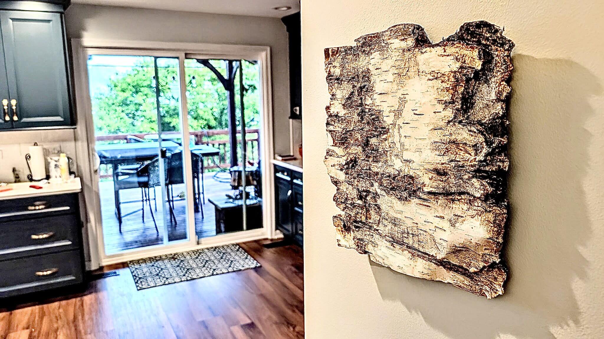 Modern interior with wood-inspired wall art and glass doors leading outside.